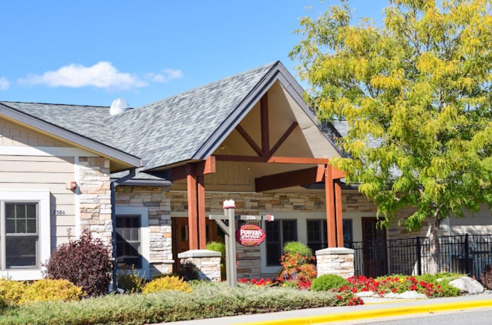 Main entrance of Moorberg Cottage featuring a stone facade and landscaping.