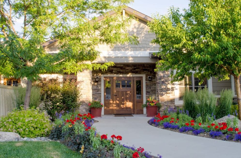 Front entrance of Moorberg Cottage with flowers and greenery