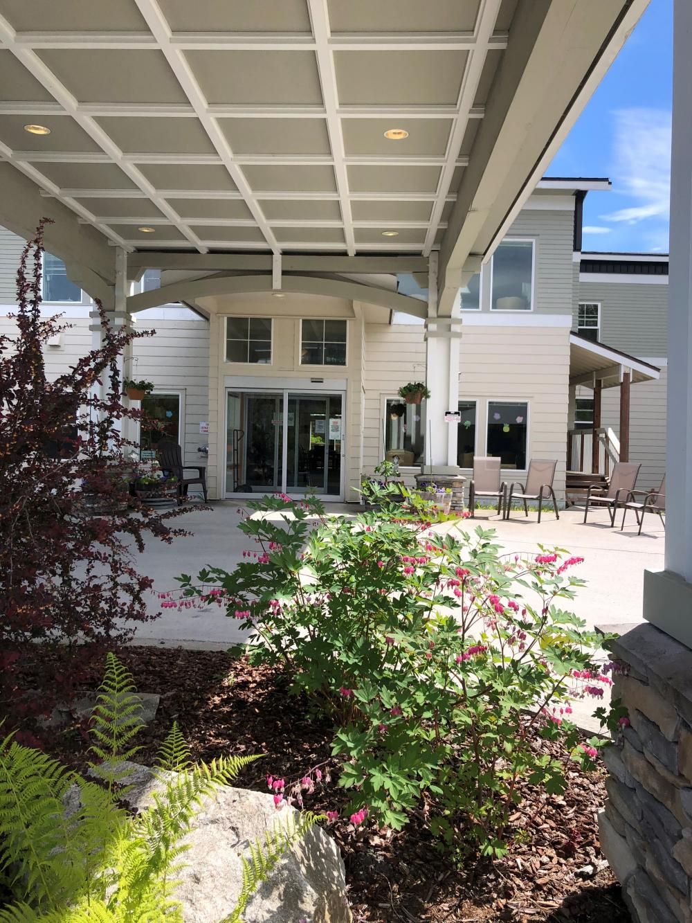 Entrance of Mountain View Assisted Living surrounded by gardens