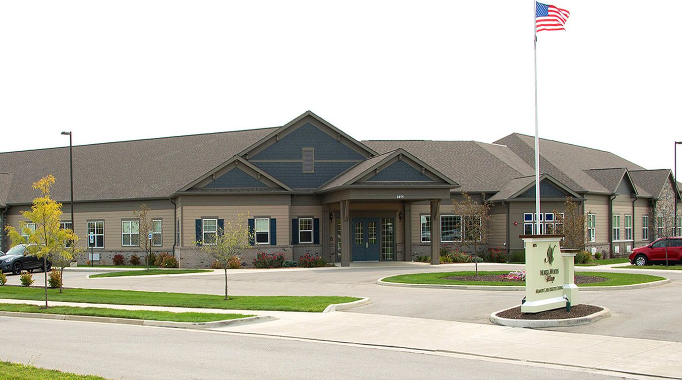 Exterior view of North Woods Village facility with landscaping