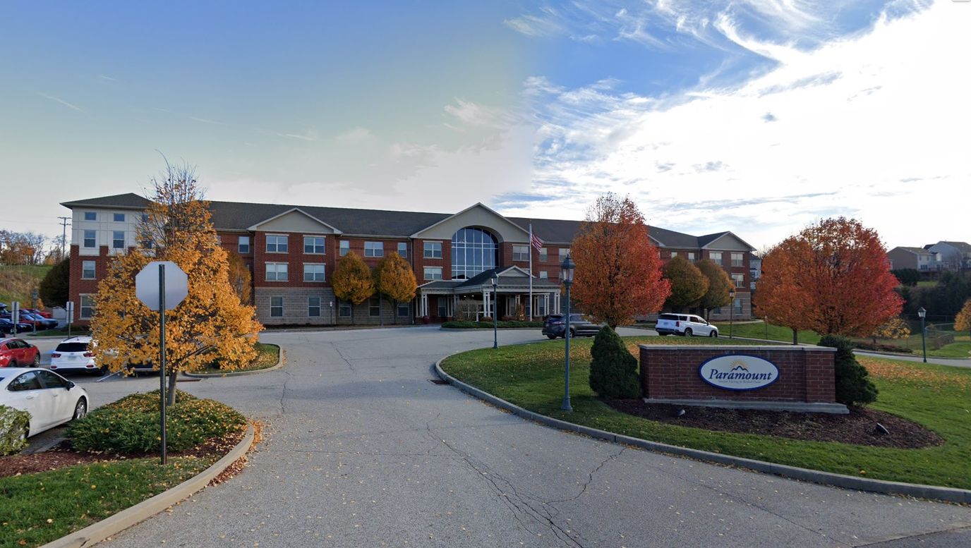 Exterior view of Paramount Senior Living with fall foliage