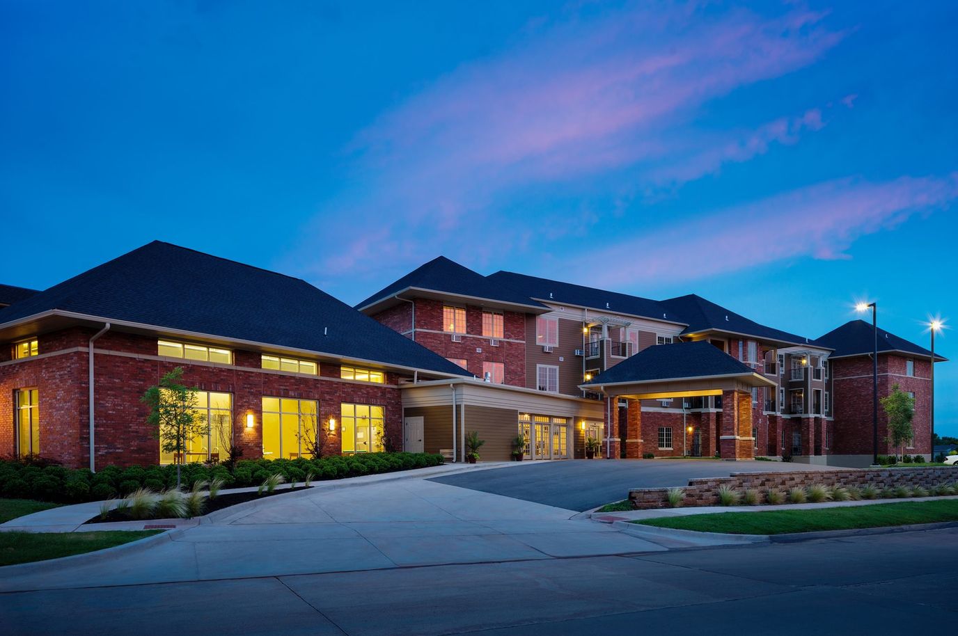Exterior view of Quail Ridge Senior Living at dusk