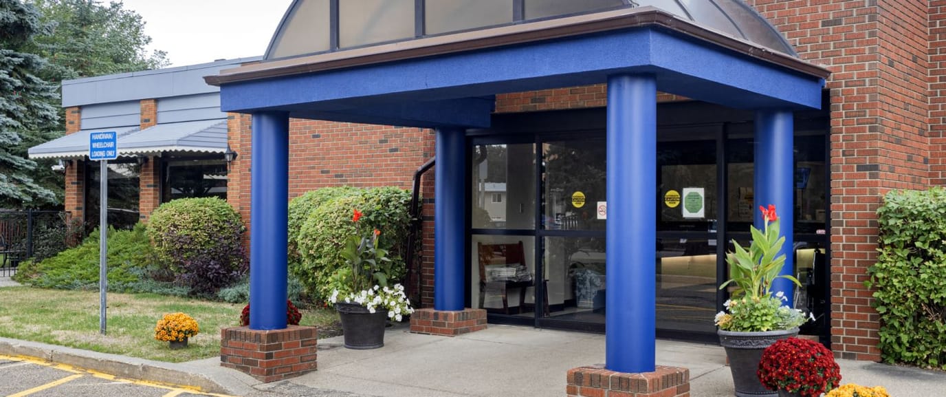 Front entrance of Rivercrest Care Centre with blue awning