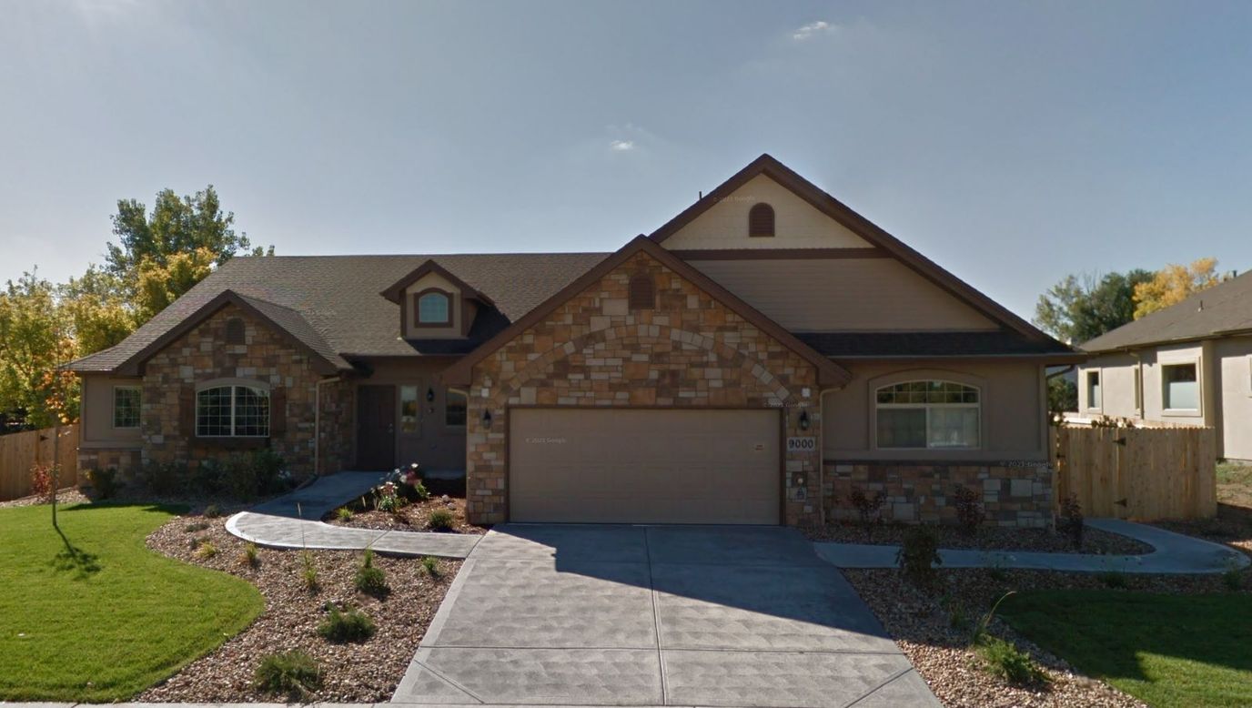 Exterior view of a residential style building with landscaped yard