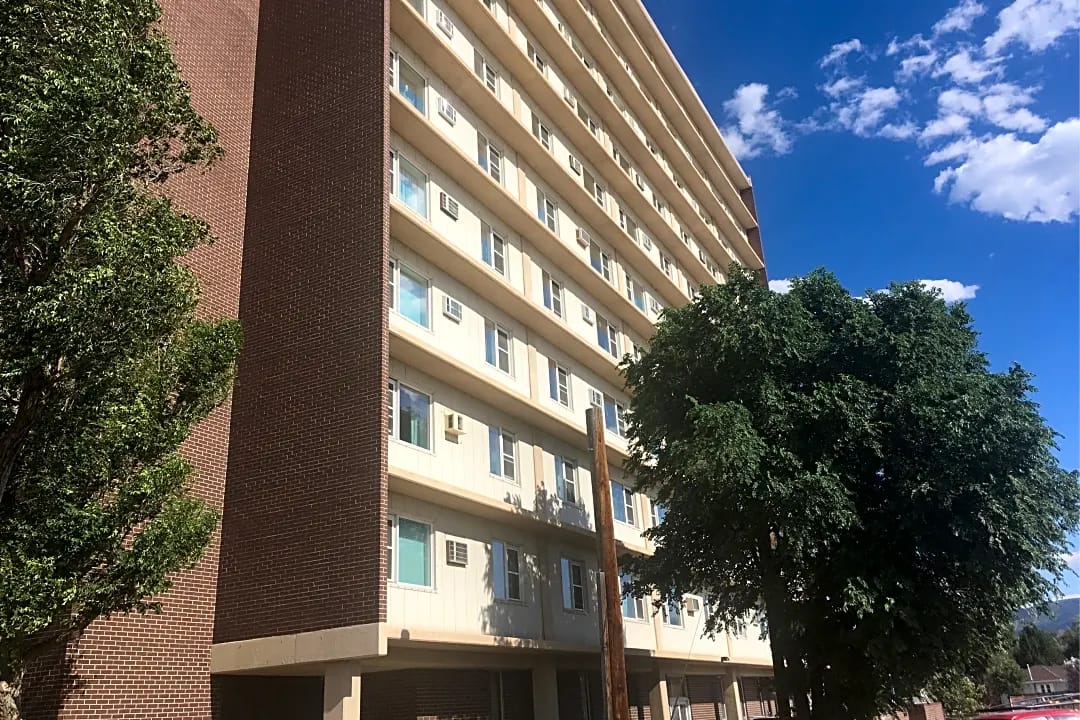 Exterior view of Skyline Towers building surrounded by trees