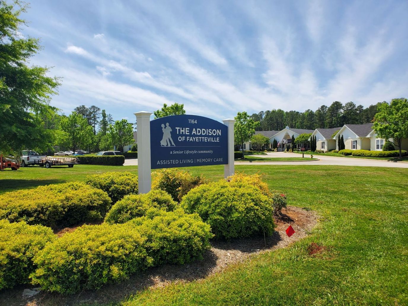 Signage for The Addison of Fayetteville with landscaping