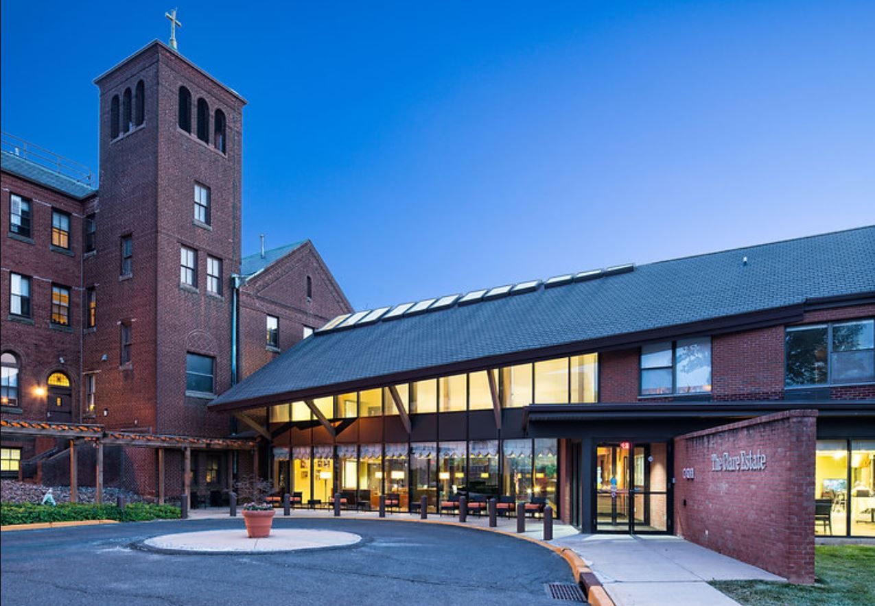 Front entrance of The Clare Estate facility at dusk