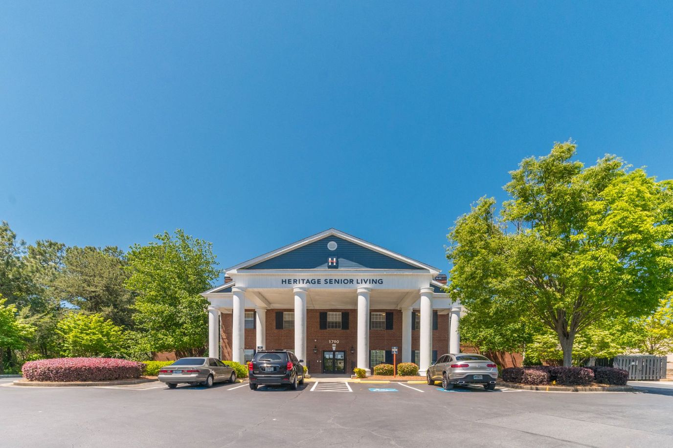 Exterior view of Heritage Senior Living building with landscaping