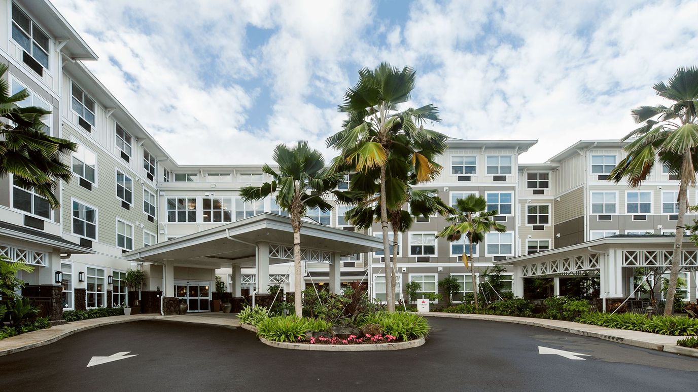 Exterior view of The Plaza at Kaneohe with palm trees