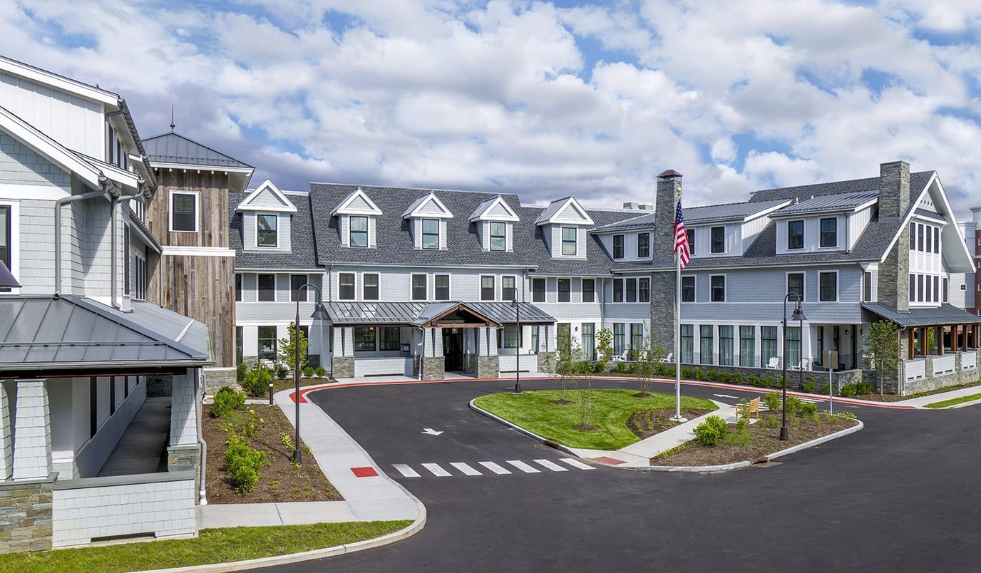 Exterior view of a senior living facility with landscaped entrance