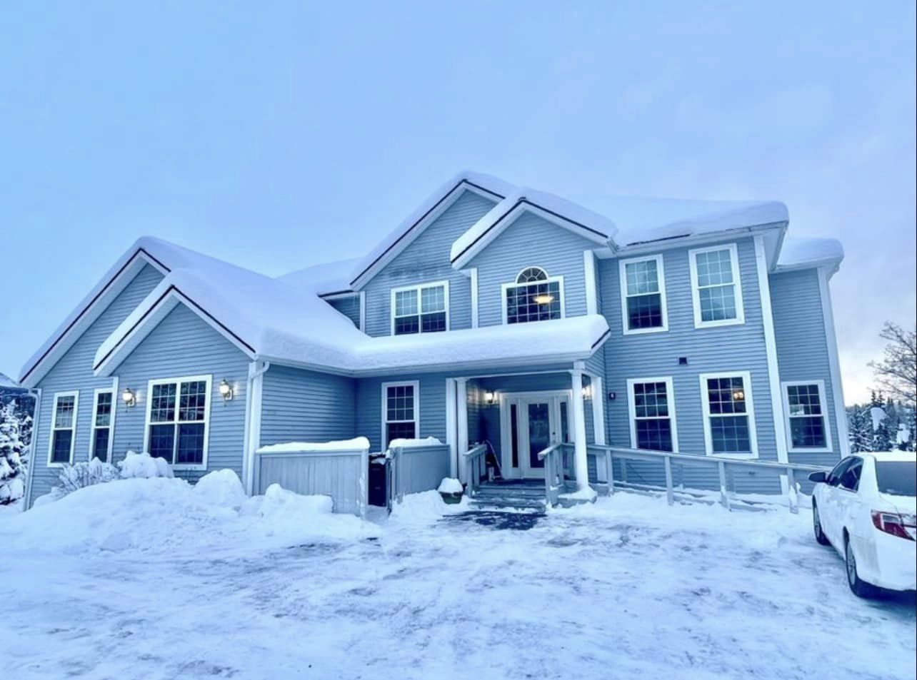 Exterior view of Thrive Assisted Living covered in snow
