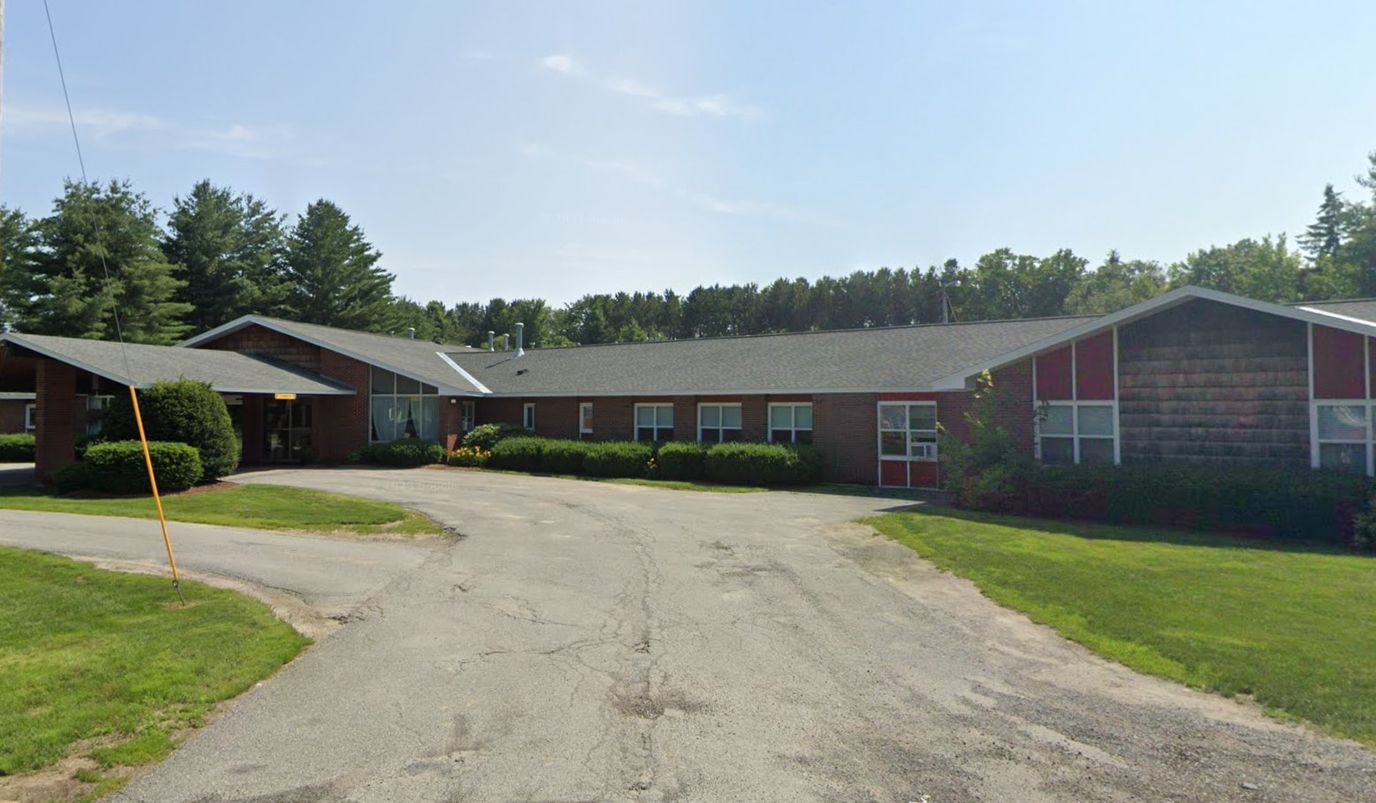Exterior view of Westgate Manor facility with landscaping
