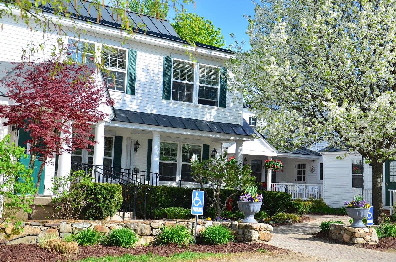 Exterior view of a senior living facility with a garden