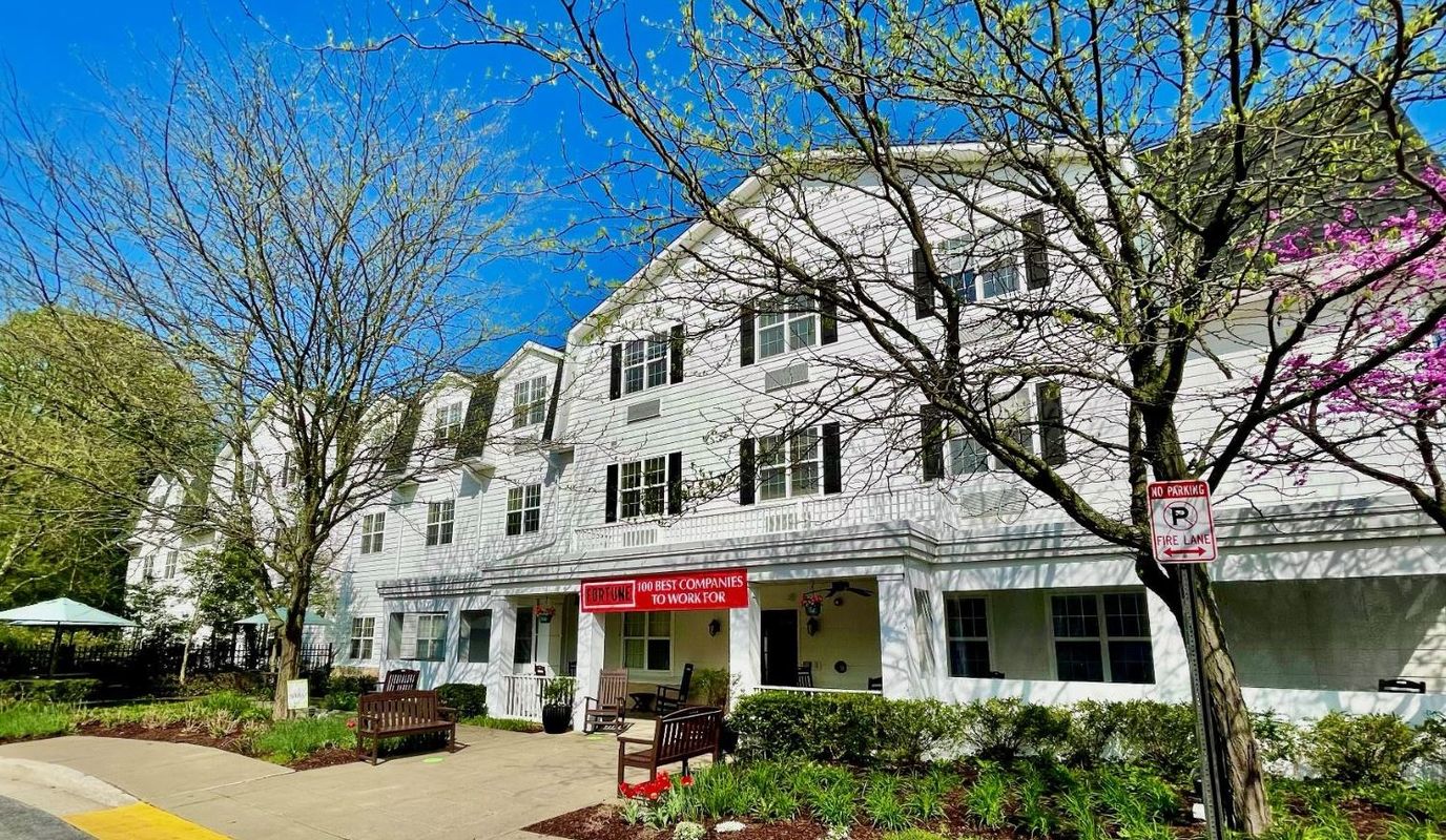 Exterior view of a senior living facility with landscaped path