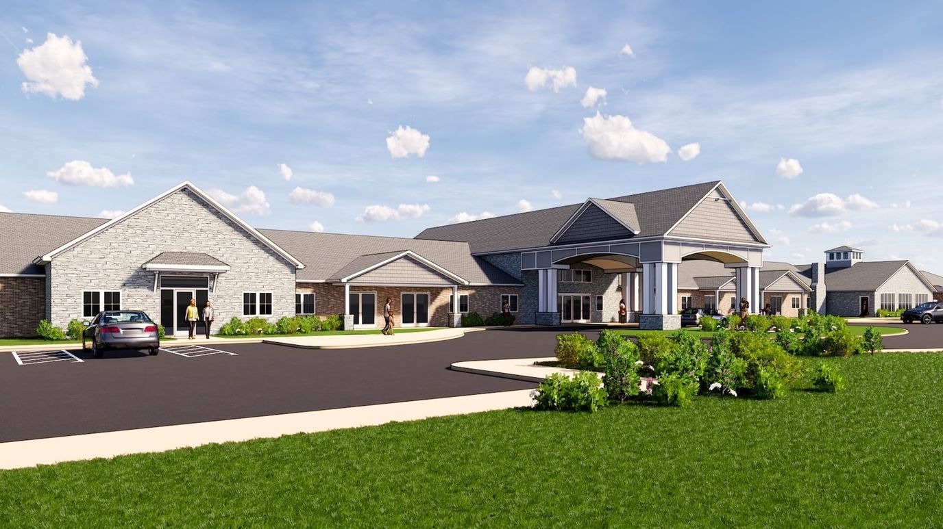 Exterior view of Cedarhurst of Topeka with gardens and vehicles