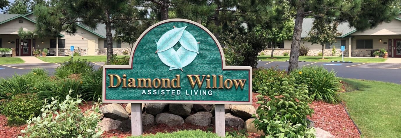 Sign for Diamond Willow Assisted Living with landscaping
