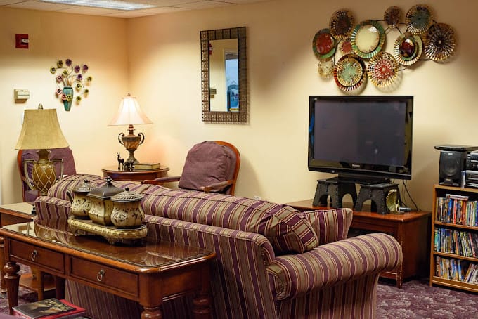 Comfortable living room with a couch, lamp, and TV