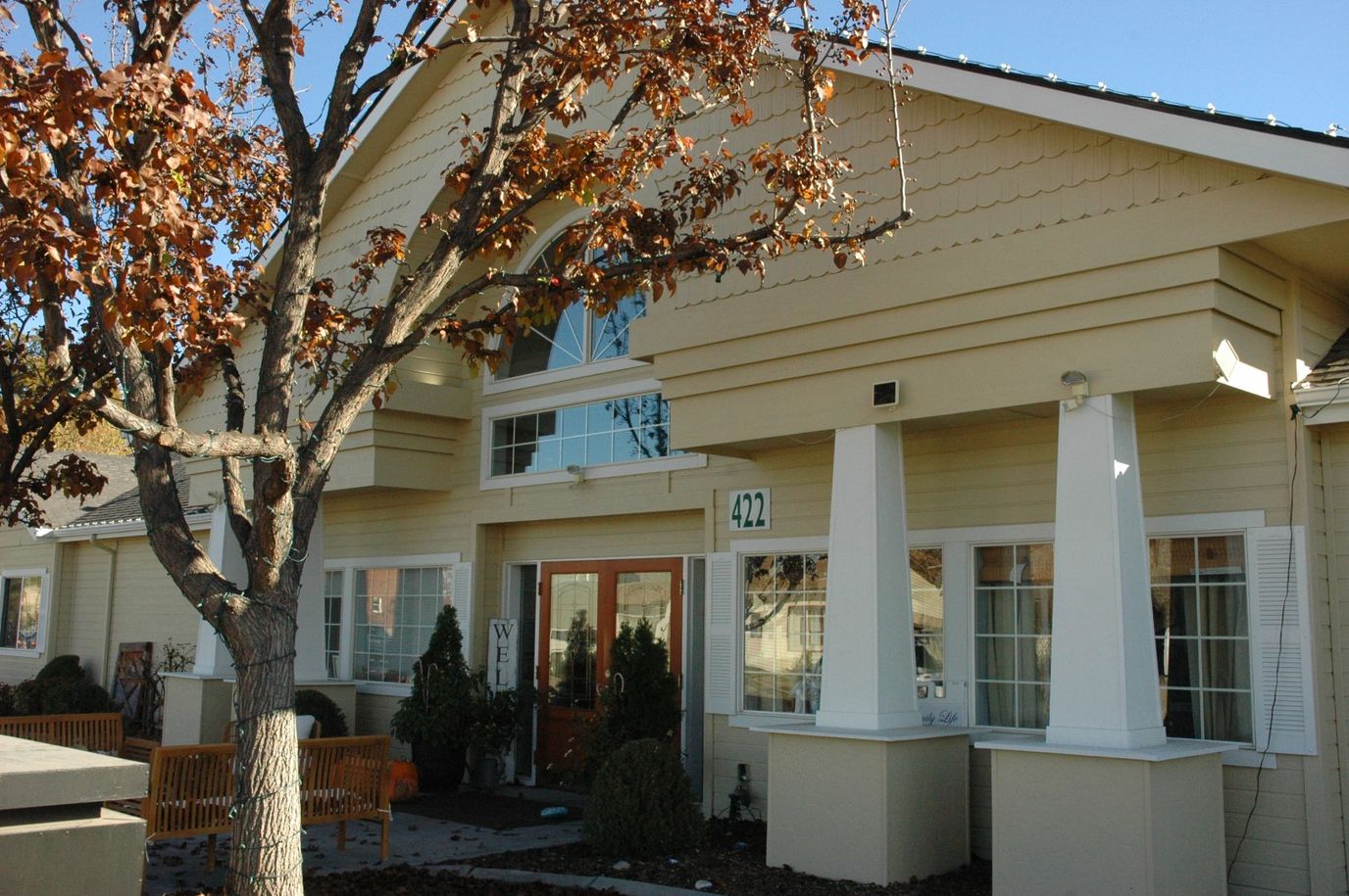 Exterior view of a senior care facility surrounded by trees