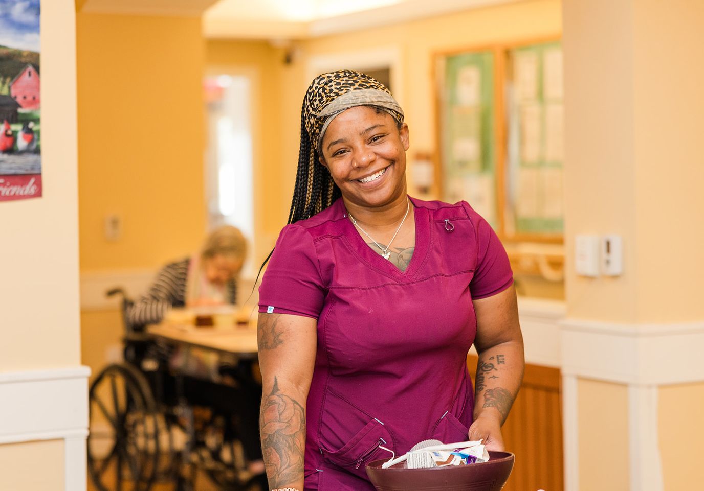 Staff member smiling in a facility hallway