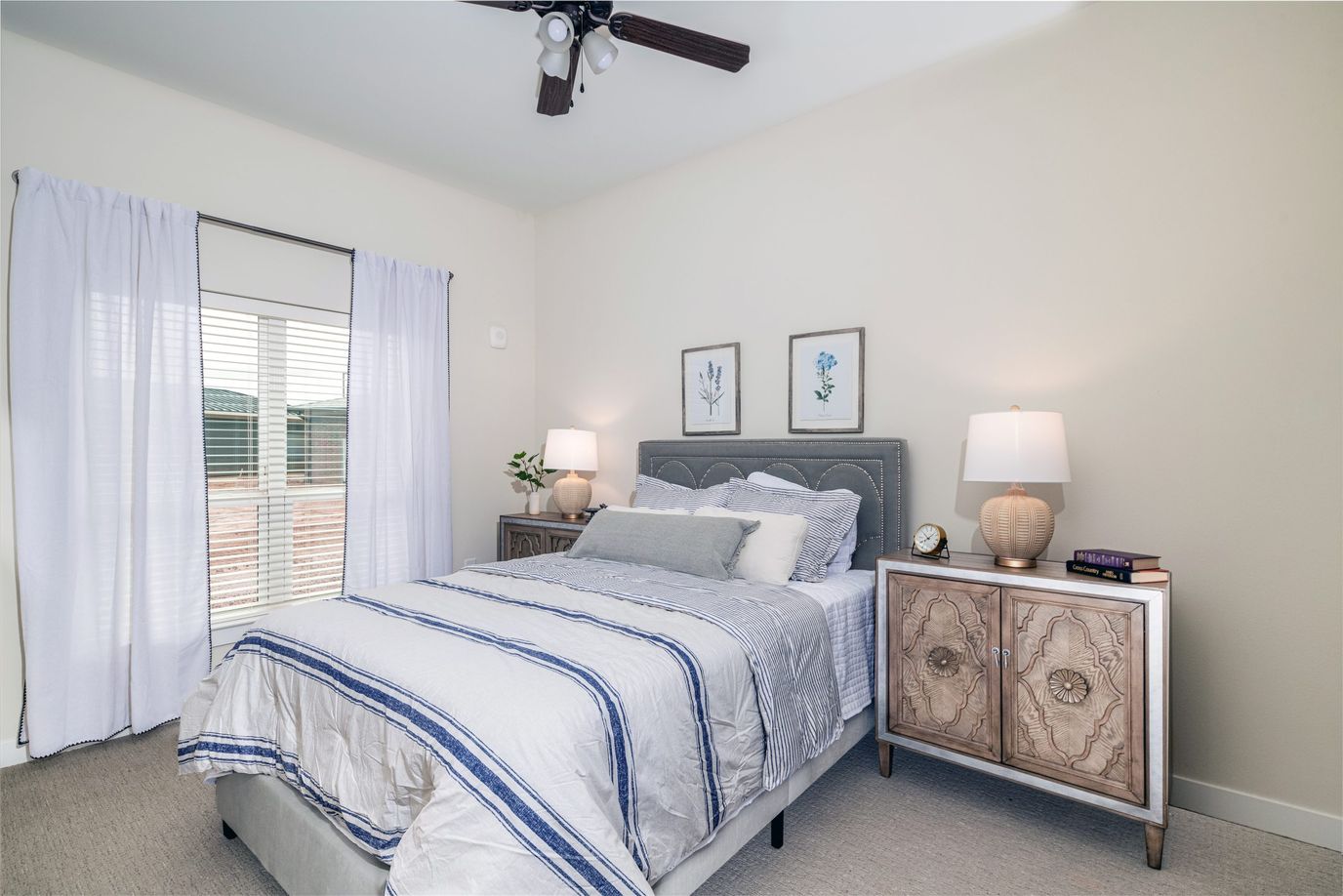 Sooner Station Senior Living, assisted living in Norman, OK — Cozy bedroom with a bed and decorative nightstands