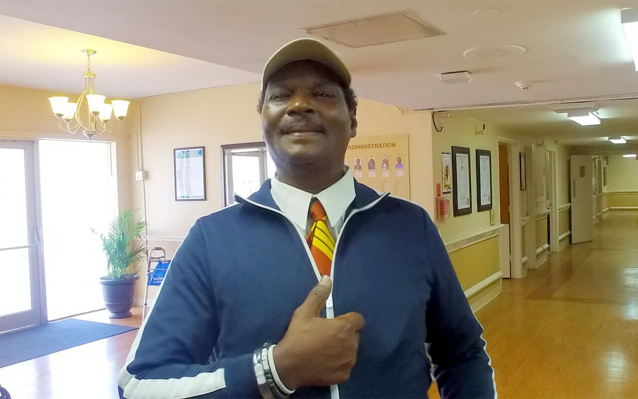 Staff member posing with a thumbs-up in the facility