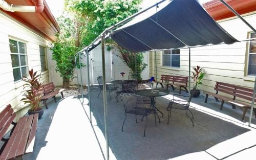South Heritage Health & Rehabilitation Center, Nursing Home in St. Petersburg, FL — Shaded outdoor seating area with tables and benches