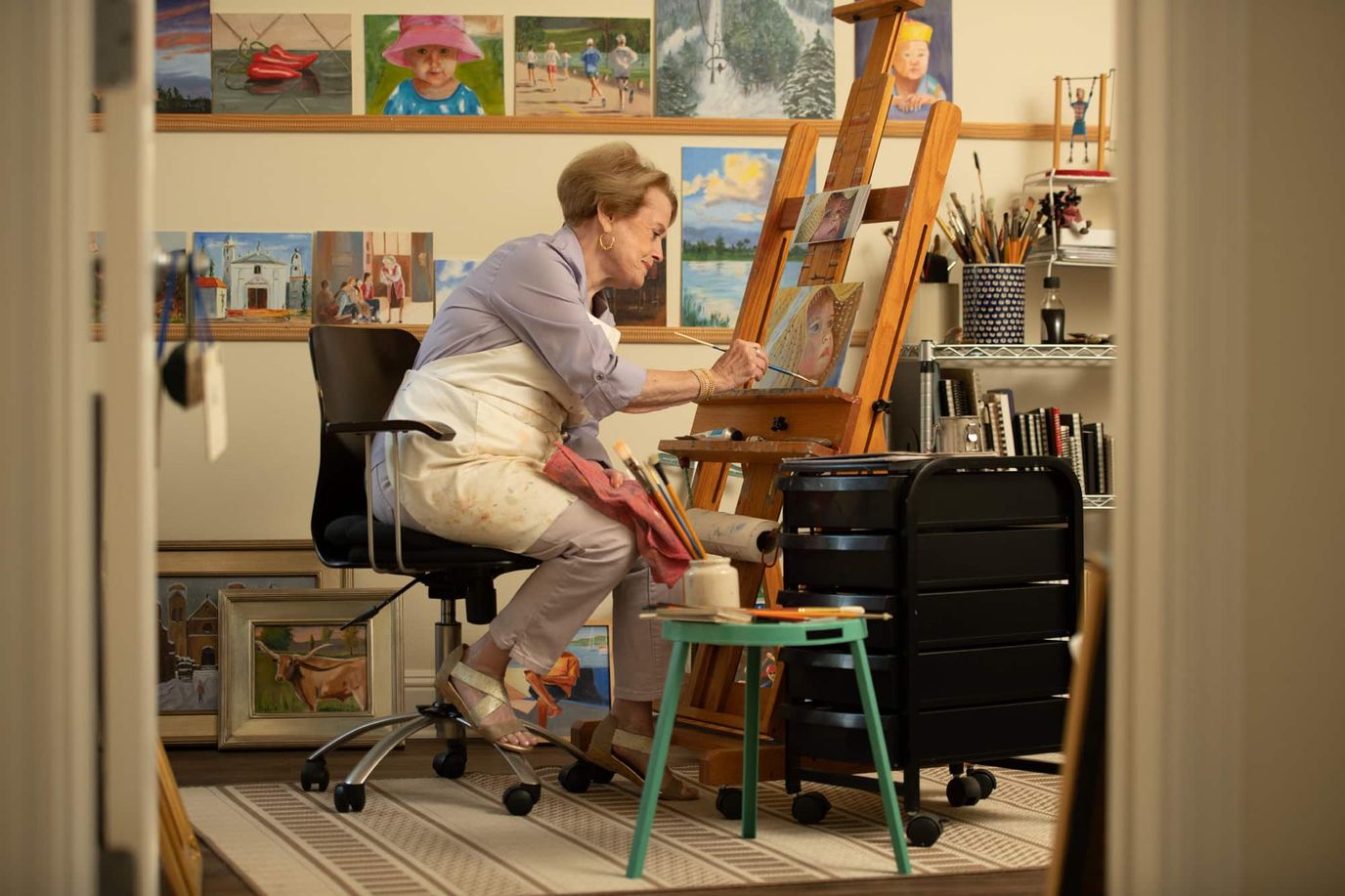 Senior painting in an art studio
