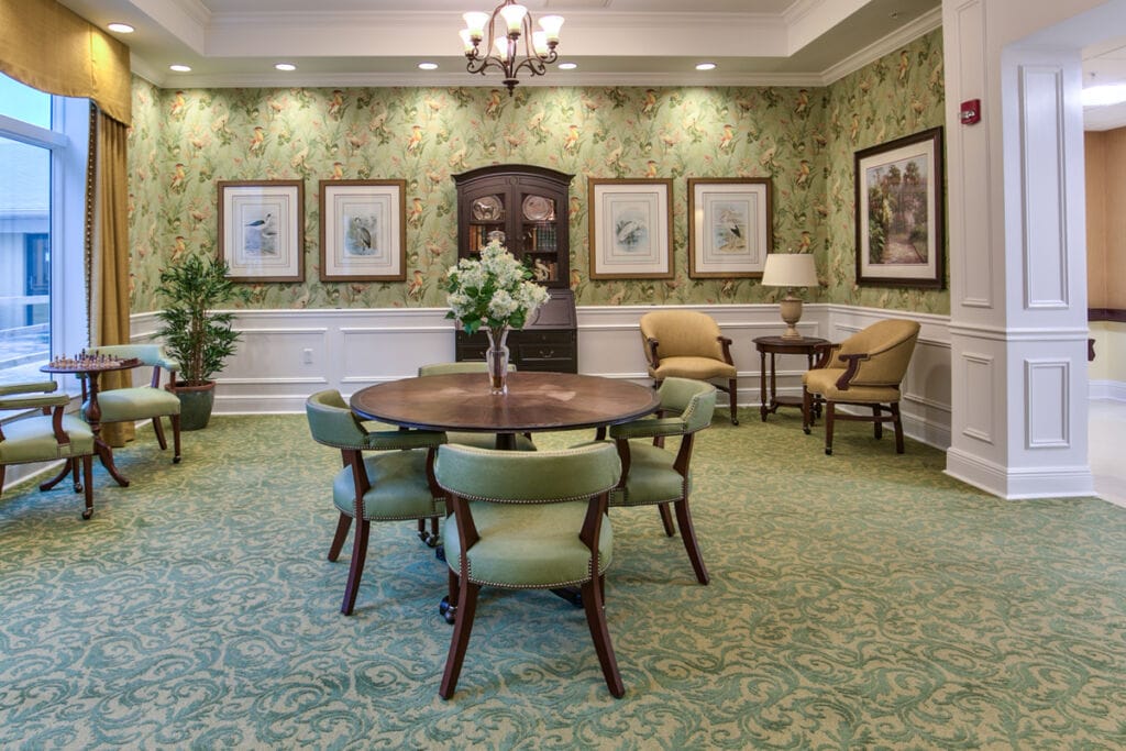 Bright common area with green decor and seating