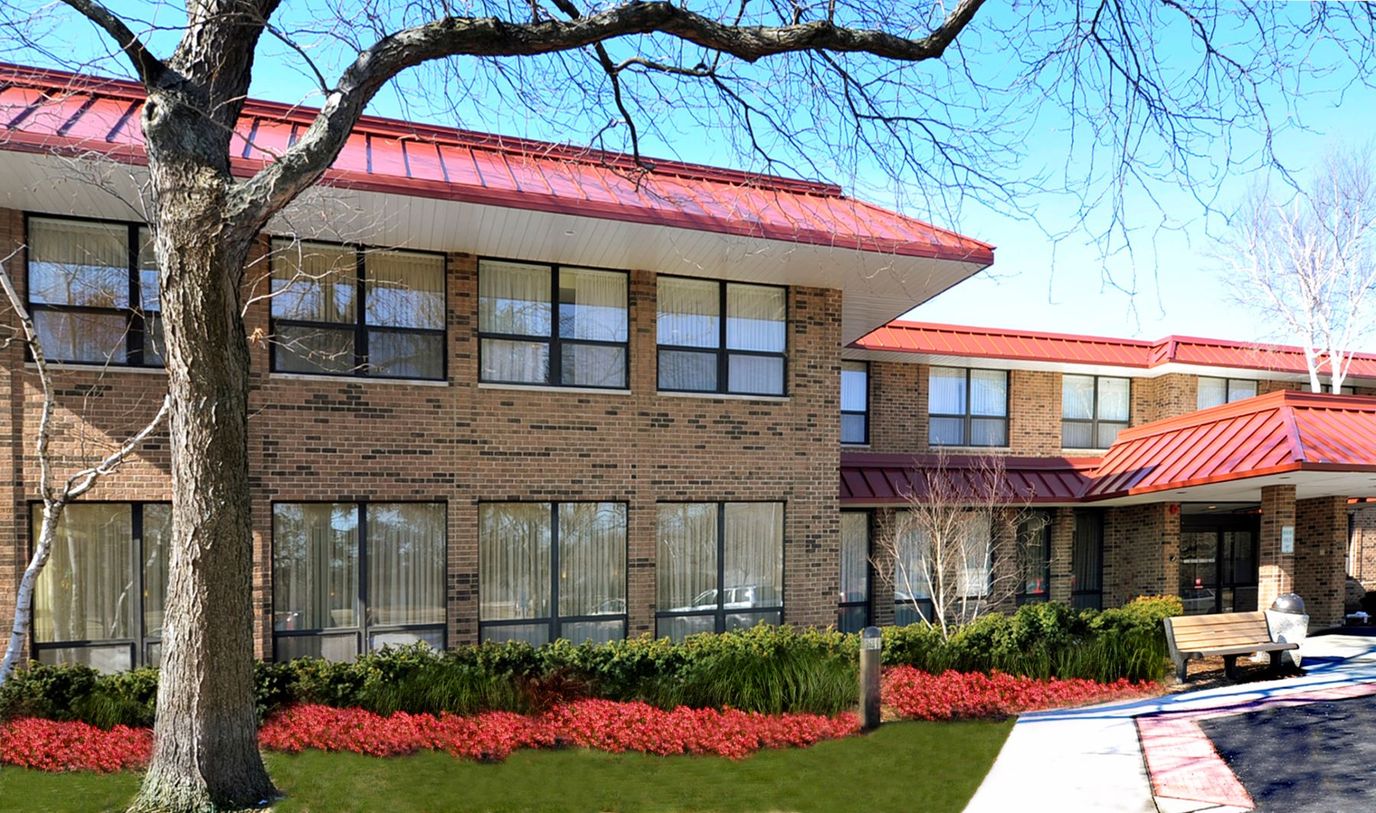 Exterior view of a senior living facility with landscaping