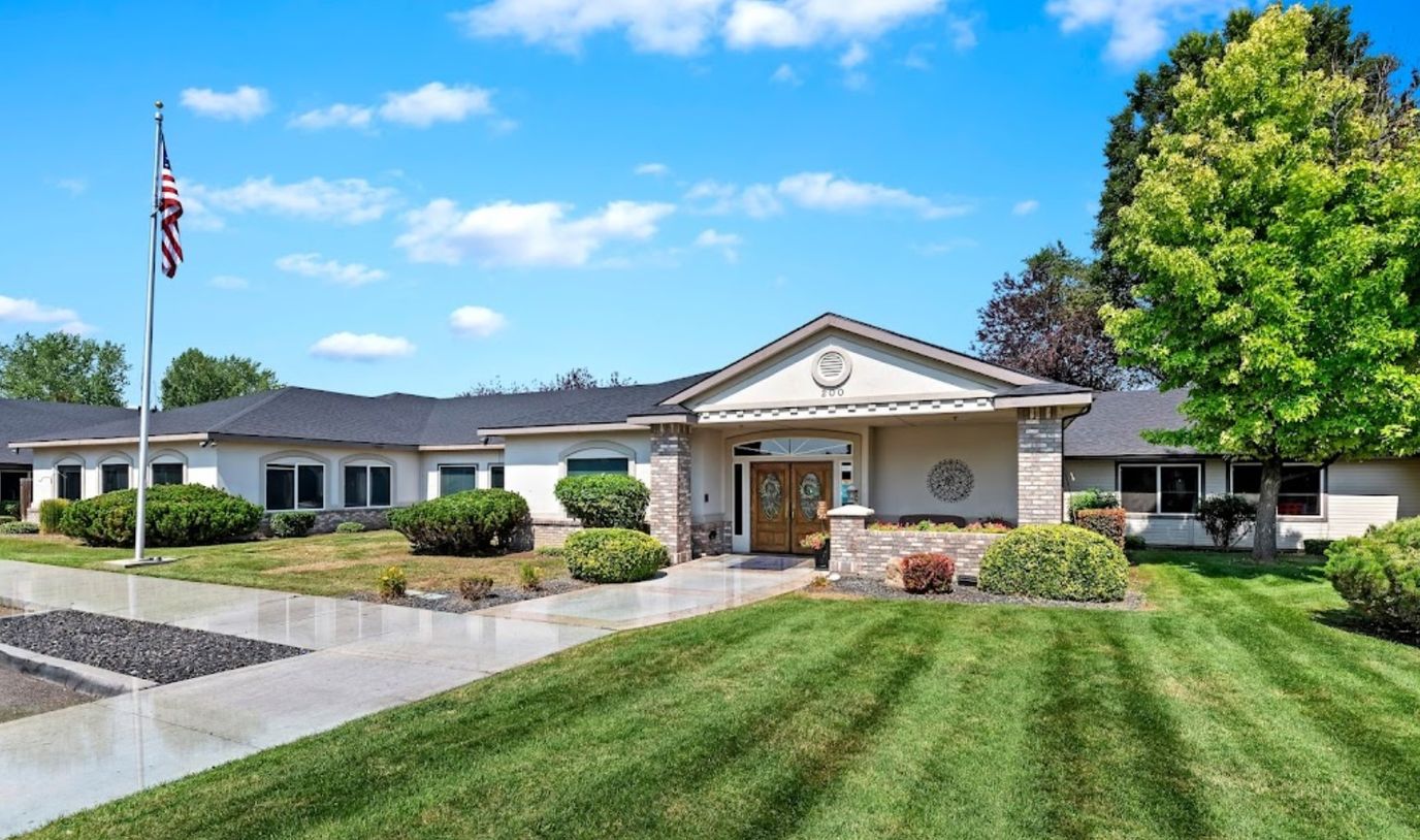 Exterior view of a senior living facility with landscaping