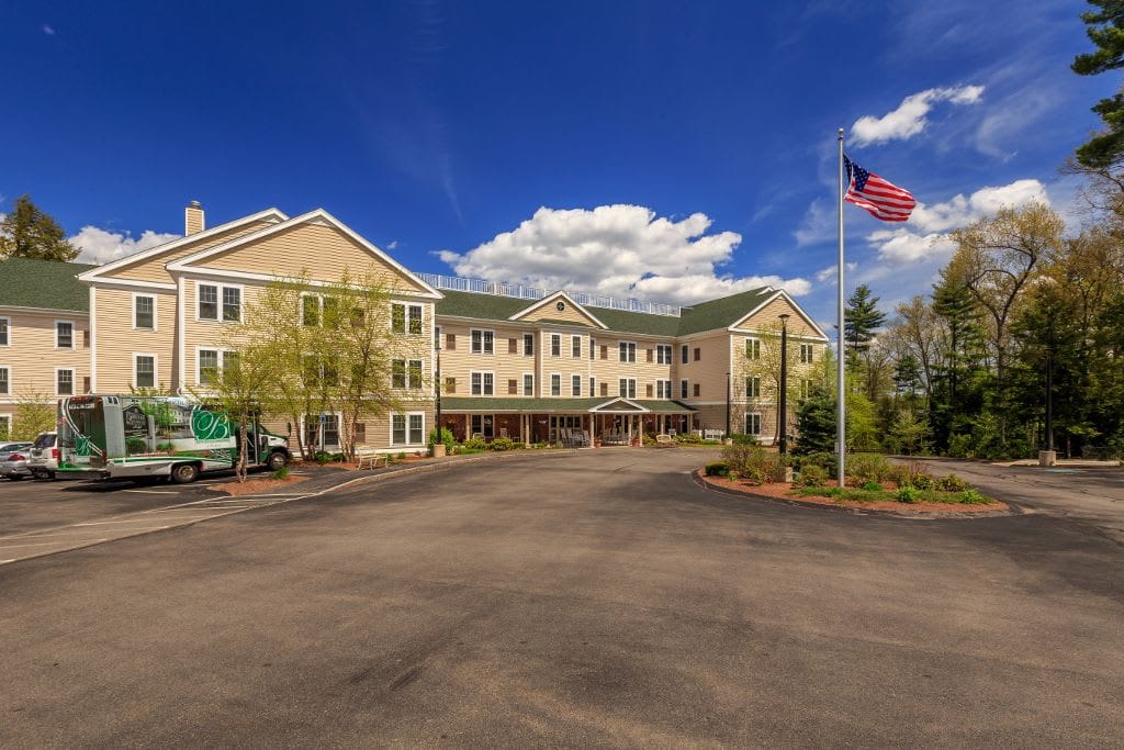 Exterior view of assisted living facility with American flag