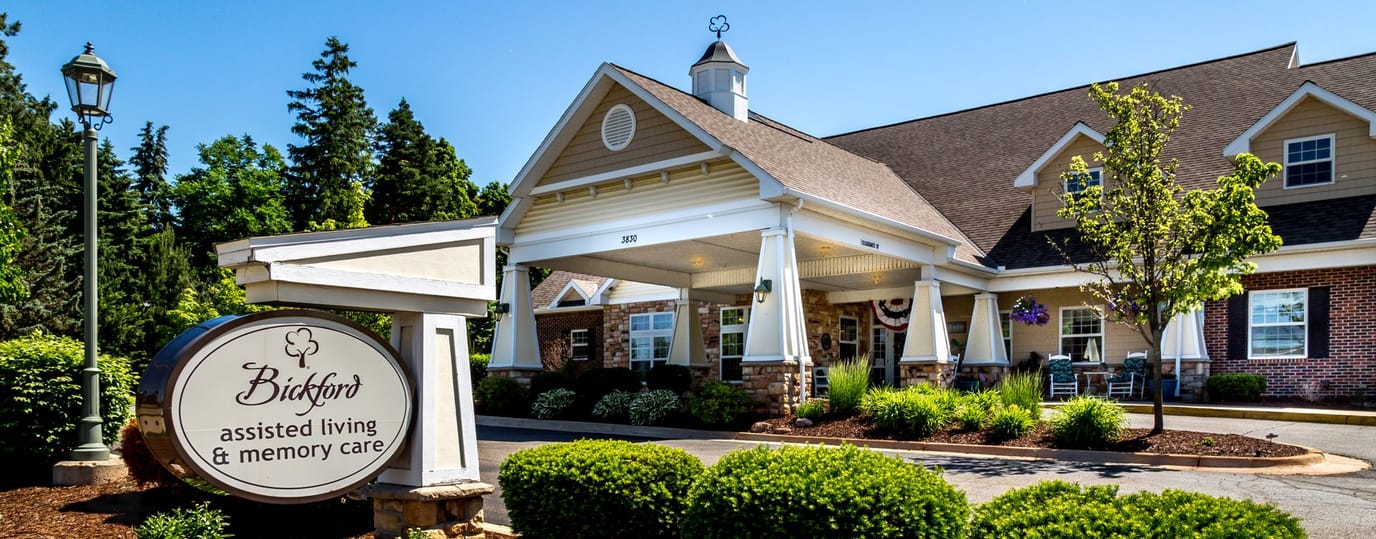 Exterior view of assisted living facility with sign