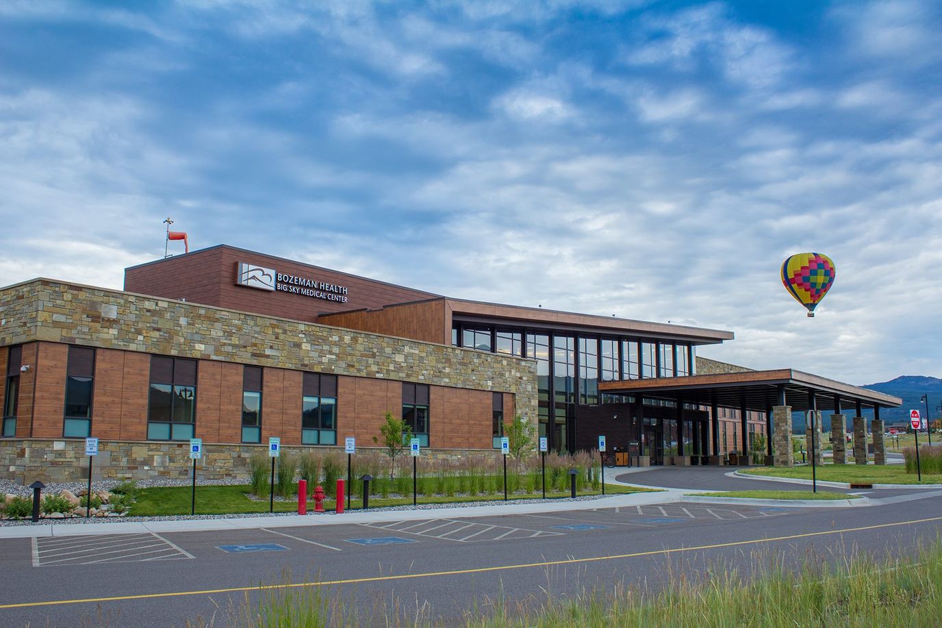 Exterior view of a healthcare facility with balloon in the sky