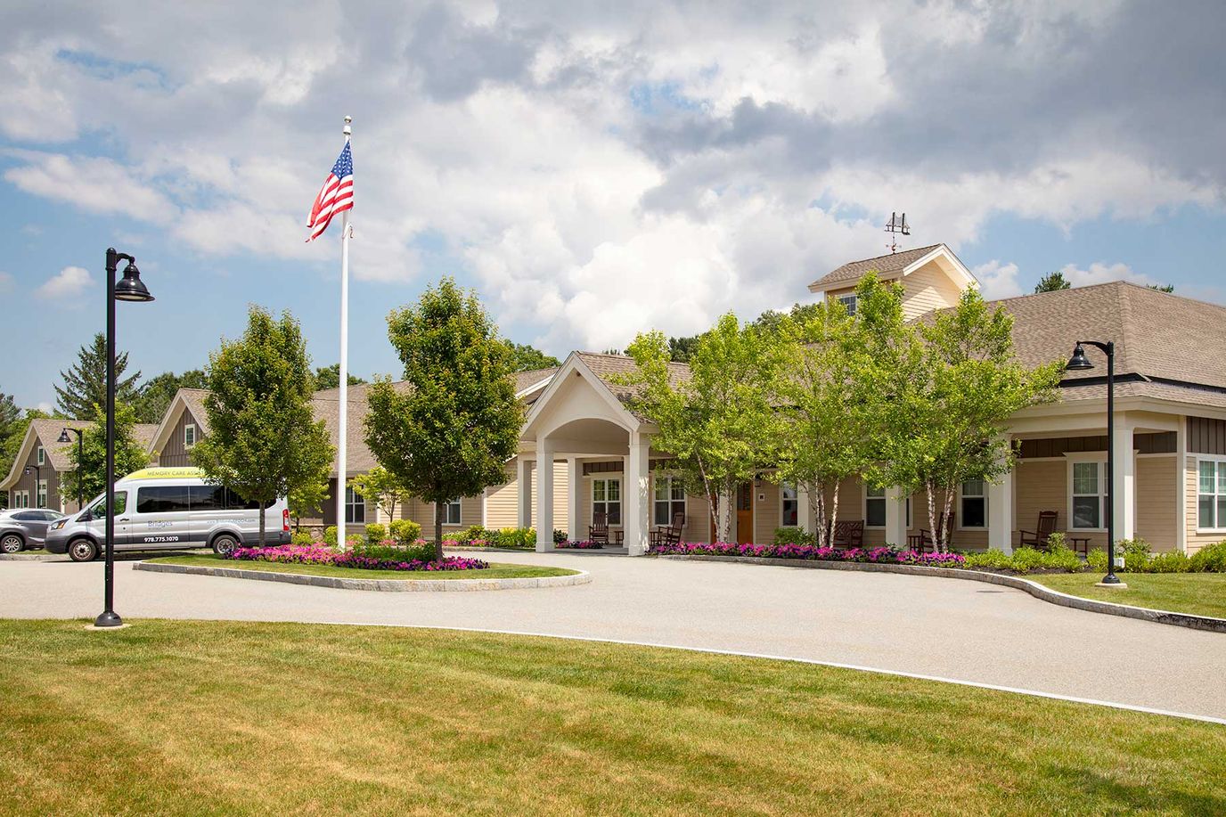 Exterior view of assisted living facility with gardens