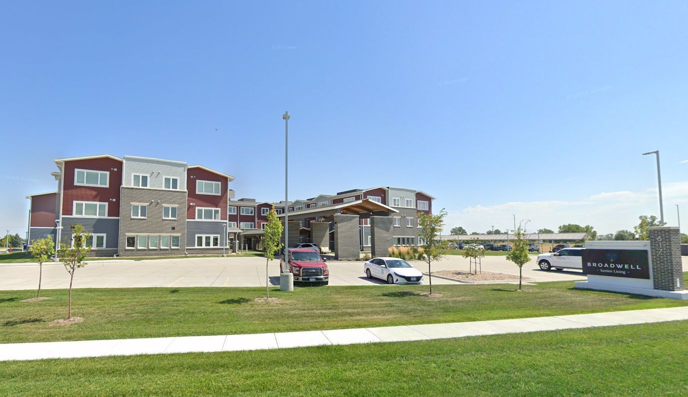 Exterior view of a senior living facility with parking