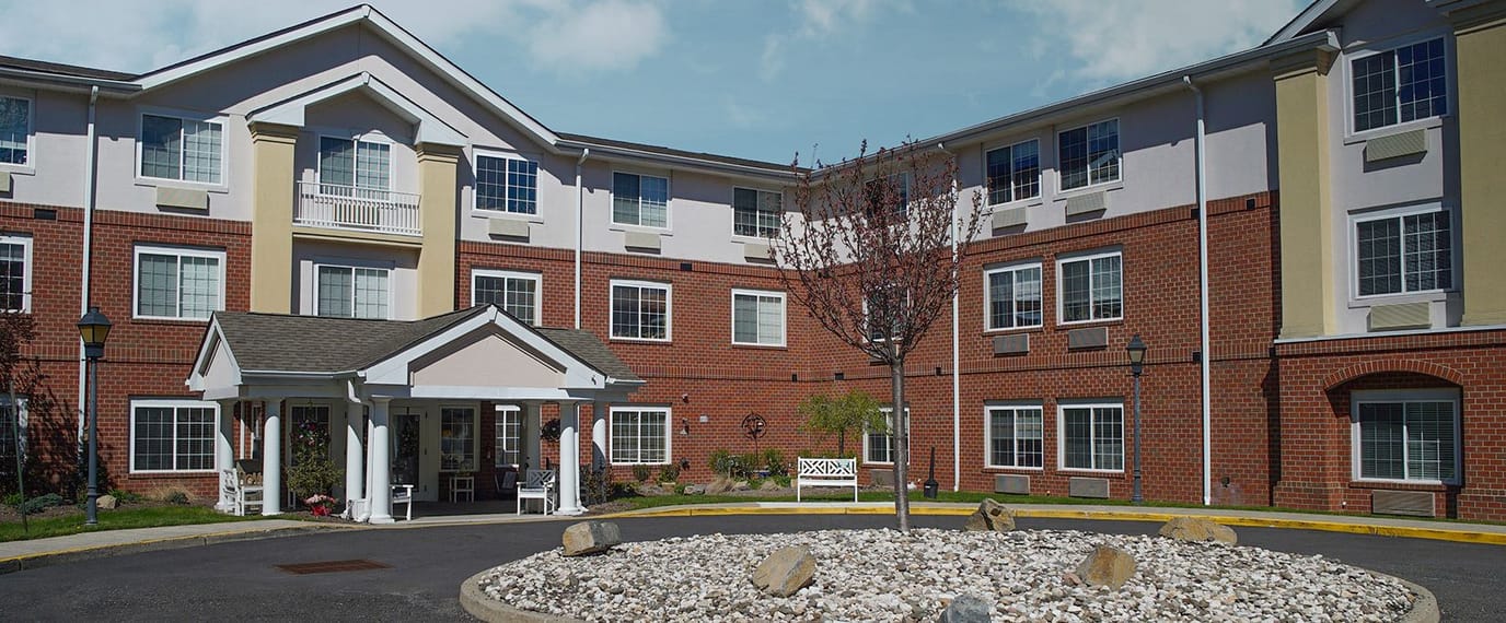Exterior view of a senior living facility with landscaping