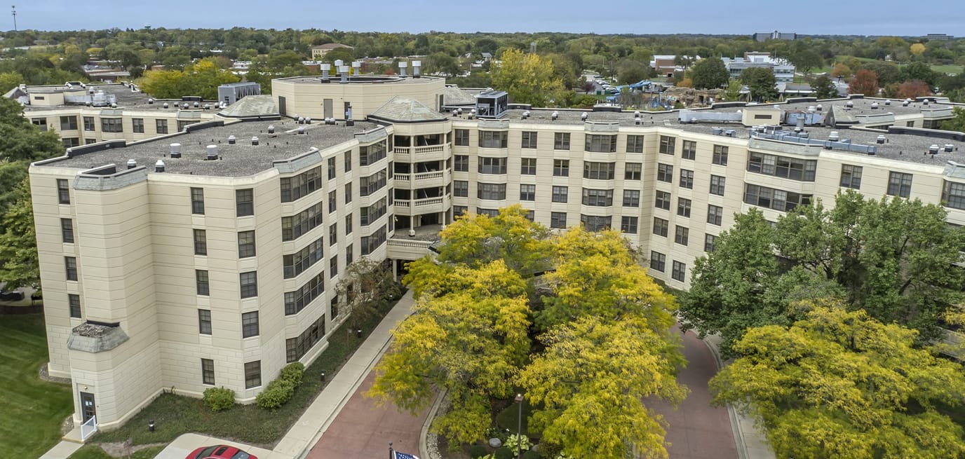 Aerial view of a senior living facility with colorful trees