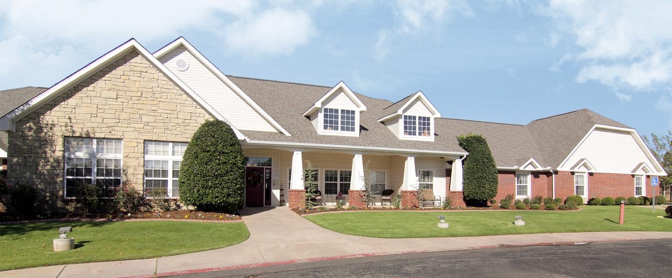 Exterior view of a senior living facility with landscaping
