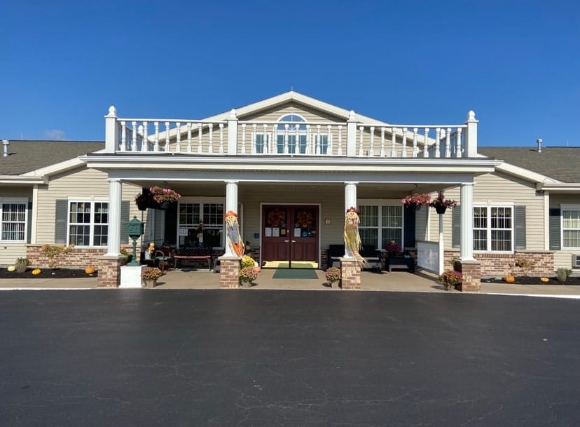 Front entrance of a senior living facility decorated for fall