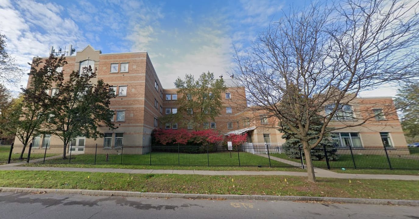 Exterior view of a senior living facility with landscaping