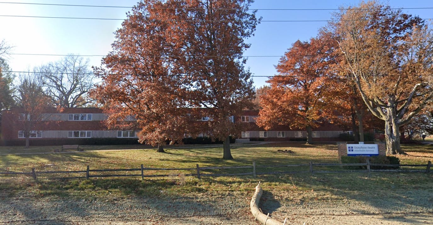 Exterior view of a senior living facility with colorful trees