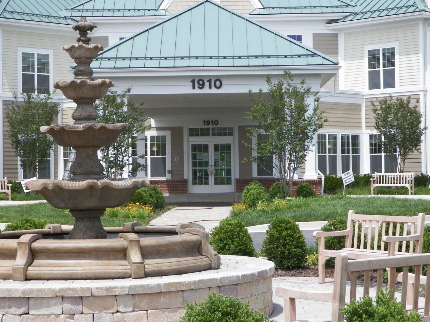Exterior view of the nursing home with a fountain