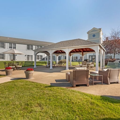 Outdoor seating area with shaded gazebo and lounge chairs
