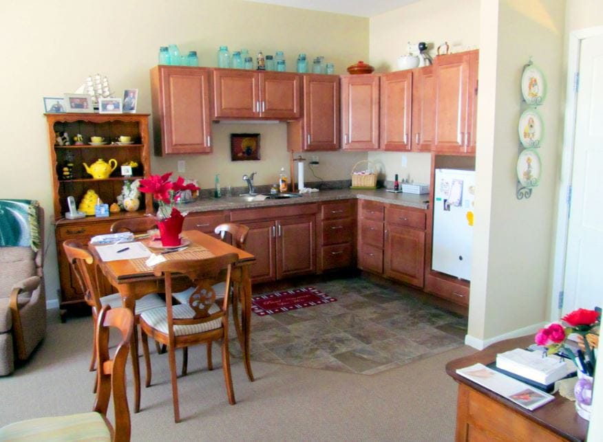 Bright kitchen with wooden cabinets and dining table.