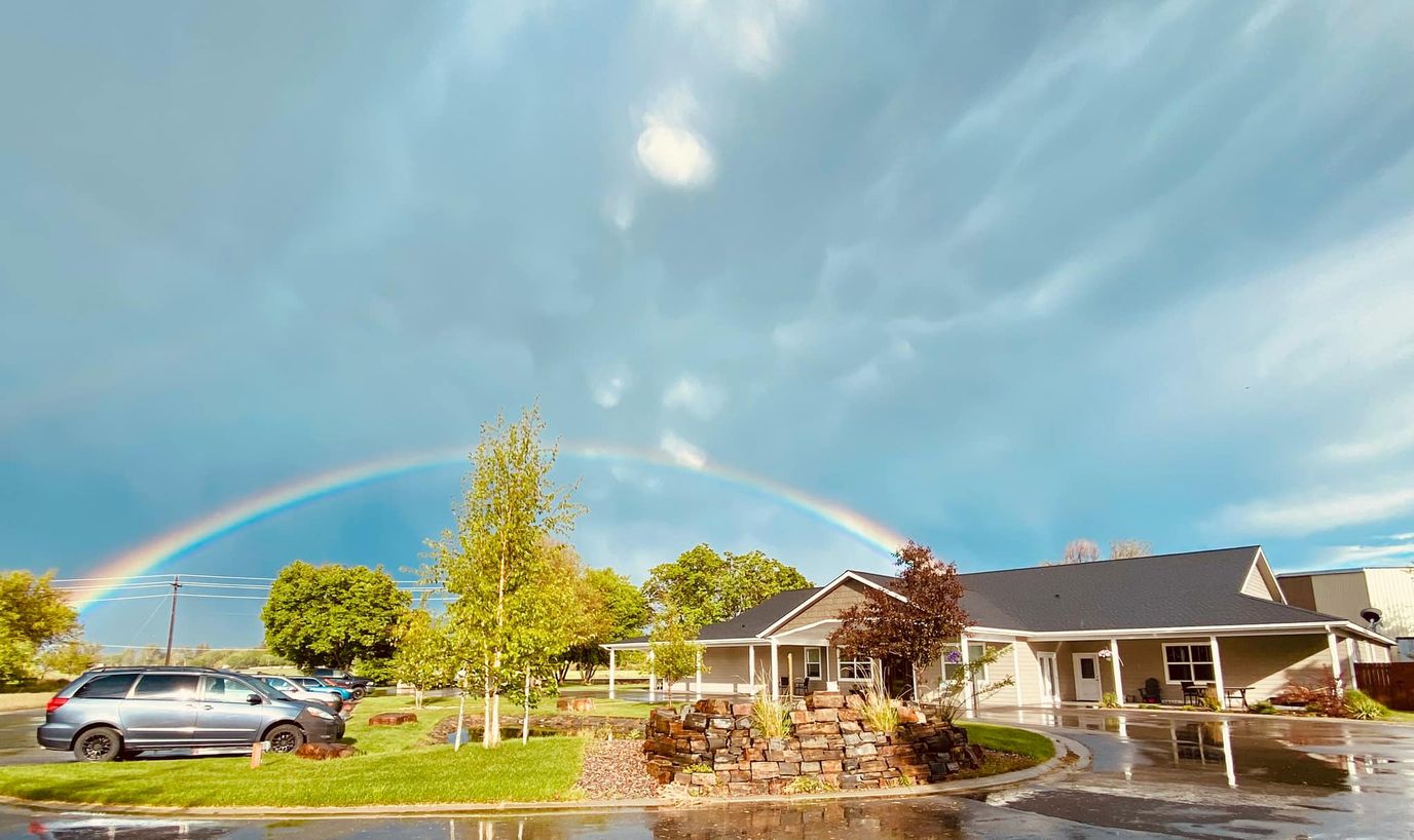 Exterior view of Hamilton House with a rainbow