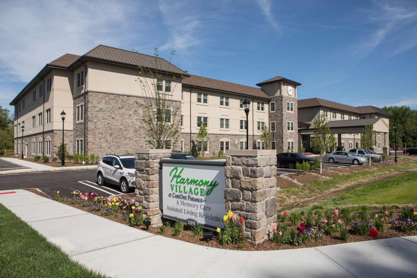 Exterior view of Harmony Village building with landscaping