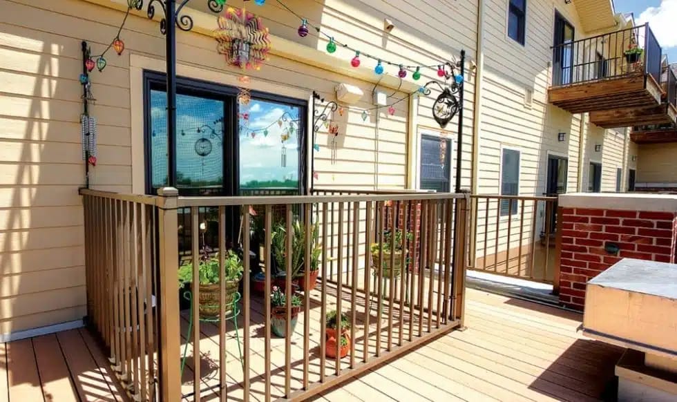 A colorful balcony with plants and decorative lights.