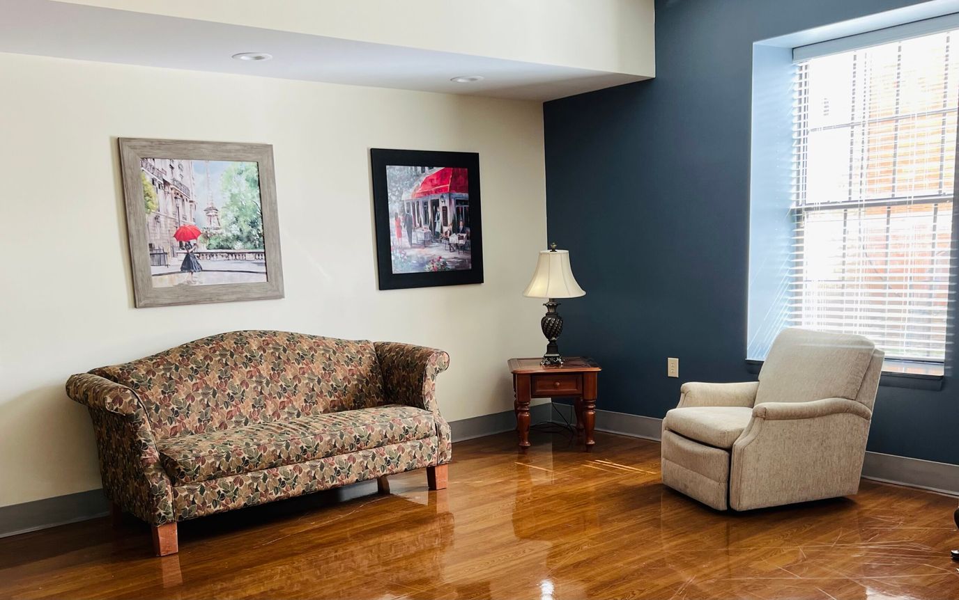 A cozy common area with a sofa and armchair