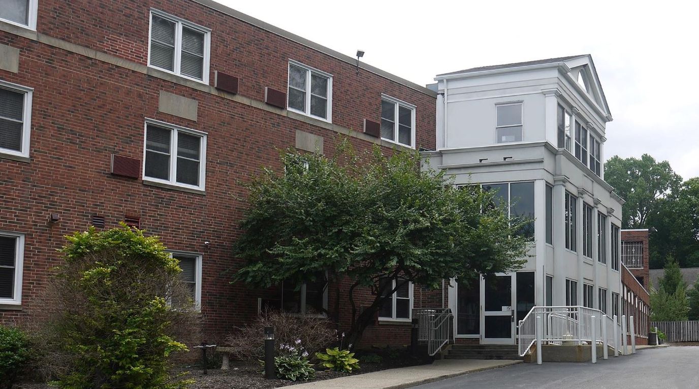 Exterior view of Cedarwood Plaza facility with landscaping