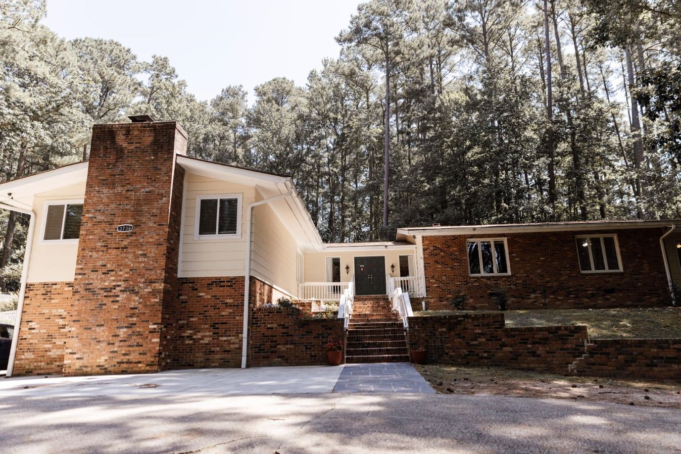 Exterior view of a senior living facility surrounded by trees